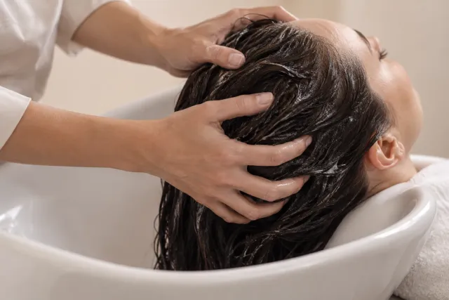 A gentle scalp massage at a salon hair-washing basin